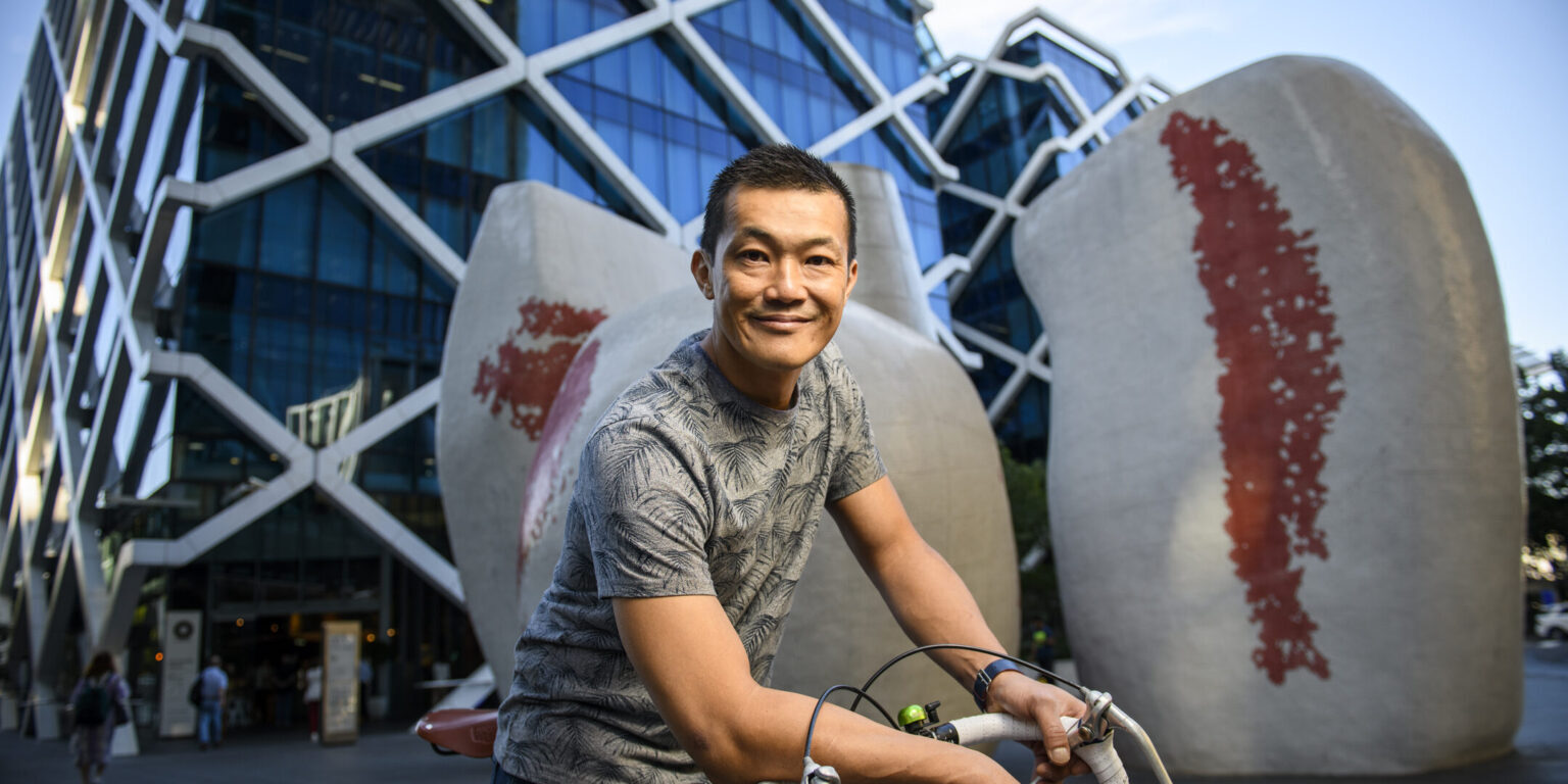 Ray Kan of Daintree Wealth on a bicycle.